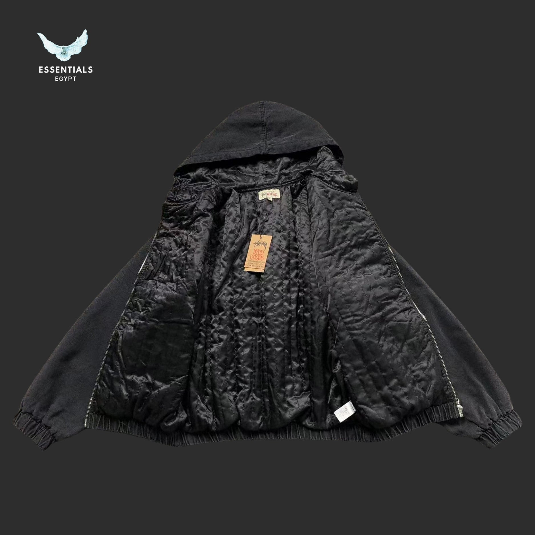 Black hooded jacket with visible branding on a dark background