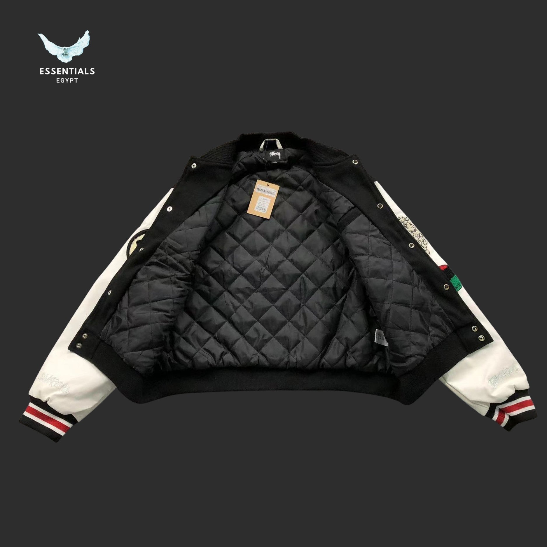 Stussy 80 Patch Varsity Jacket in black with white sleeves