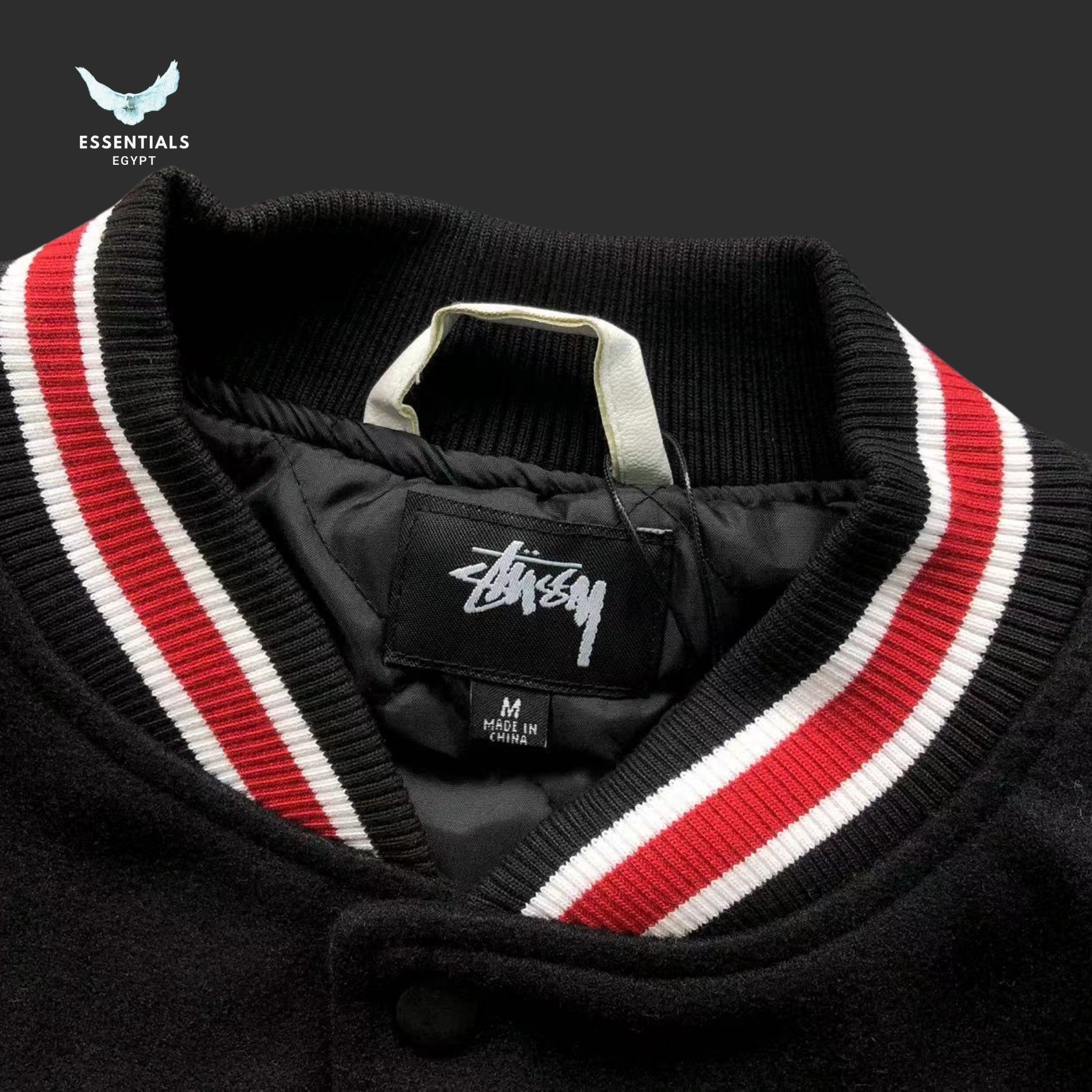 Stussy 80 Patch Varsity Jacket in black with white sleeves