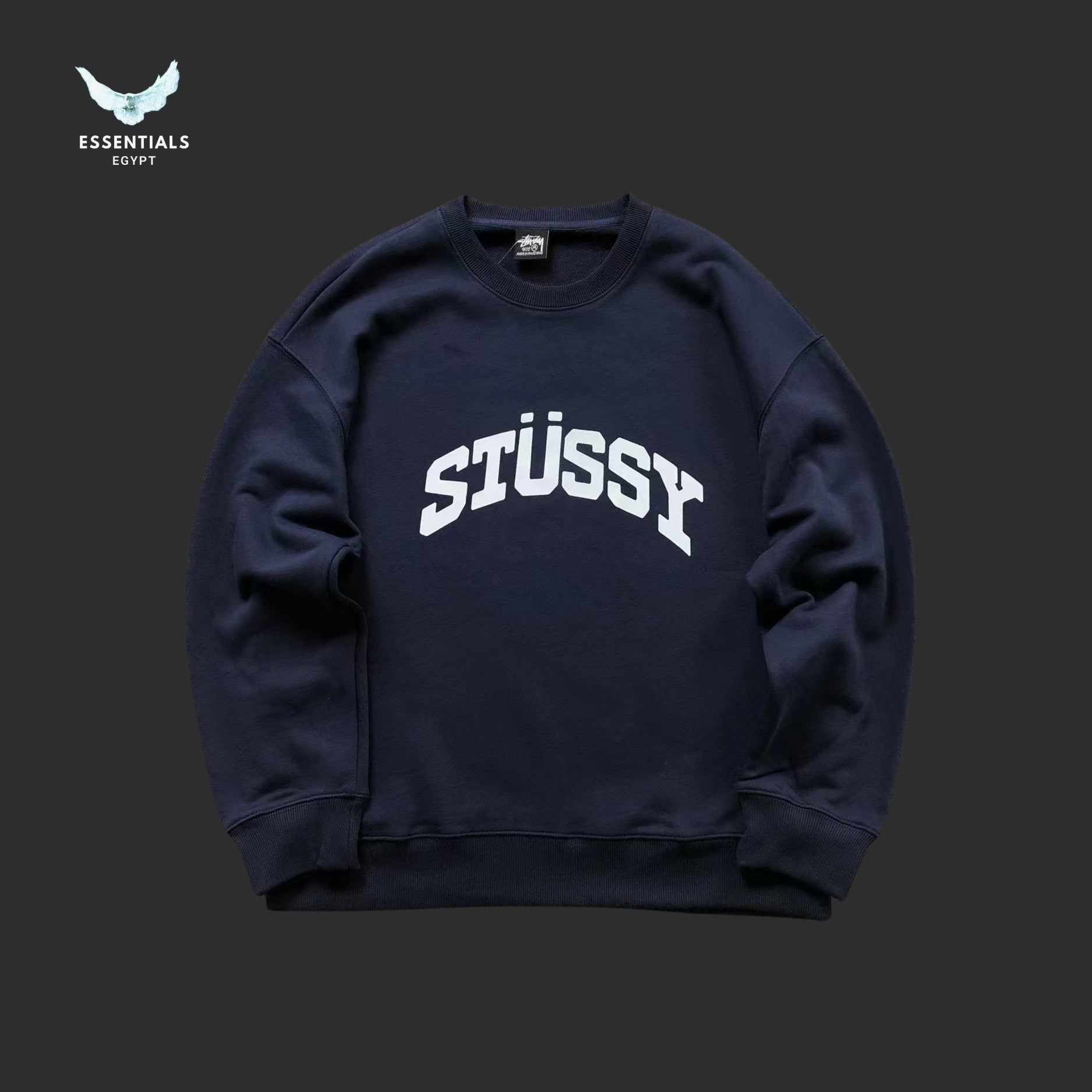 Navy blue Stussy sweatshirt on a dark background